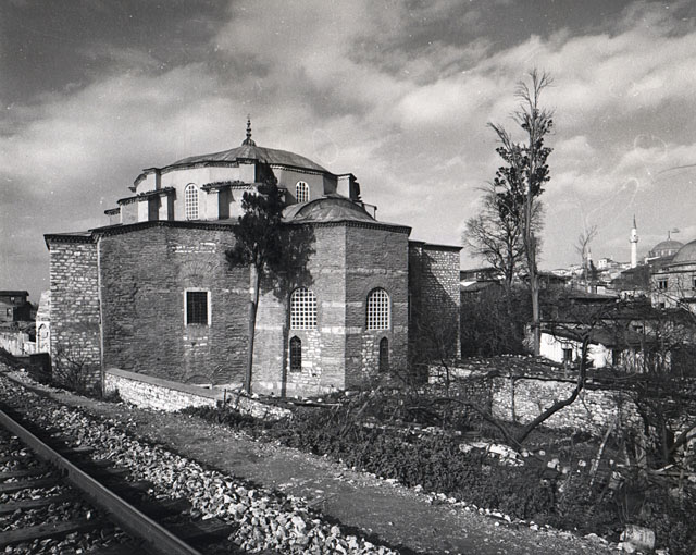 Exterior view from east-northeast, showing the mosque in its neighborhood with the railroad line to its south