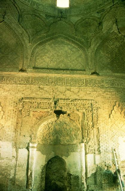 Interior view of qibla wall looking at the mihrab chamber roofed with a semi-dome and the squinches supporting the dome