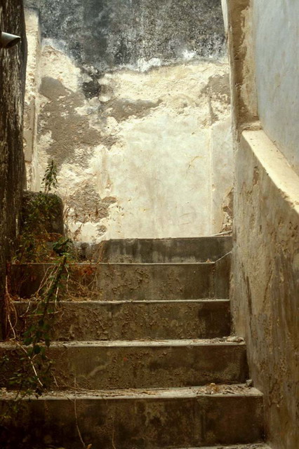 Ground floor staircase leading to  upper occupant chambers, before restoration