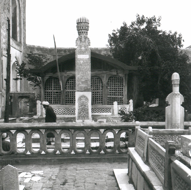 View of the wooden structure enclosing Ansari's tomb, with inscriptive marble pillar in front