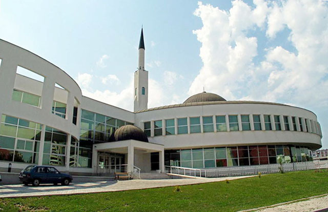 Princess Dzevhera Islamic Center - Exterior view of madrasa, with main entrance. Minaret of mosque rises behind