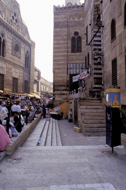 View looking south on al-Muizz street, with mosque portal seen on the right. The Khanqah-Mausoleum-Sabil-Kuttab of Sultan Qansuh Ghuri is seen on the left