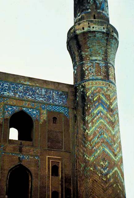 The minaret was once covered completely in green-azure majolica. Band of Quranic calligraphy still visible on the frieze