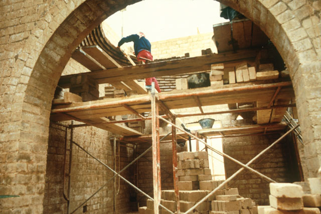 Exterior view showing construction of stone archway