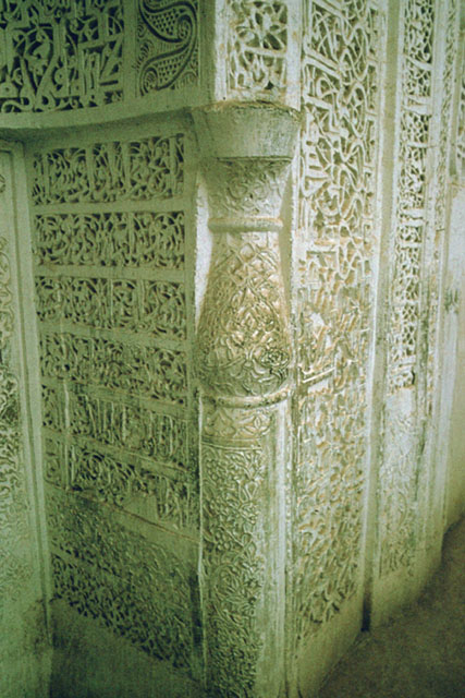 Detail of mihrab; colonette flanking niche and stucco inscriptions