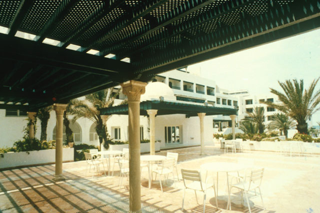 Exterior view form under covered seating area across patio
