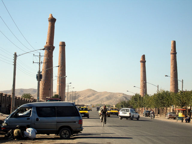View of complex from southeast, bisected by road, showing minarets remaining from Madrasa of Gawhar Shad (first left) and Madrasa of Husain Baiqara (three of four are visible in the background)