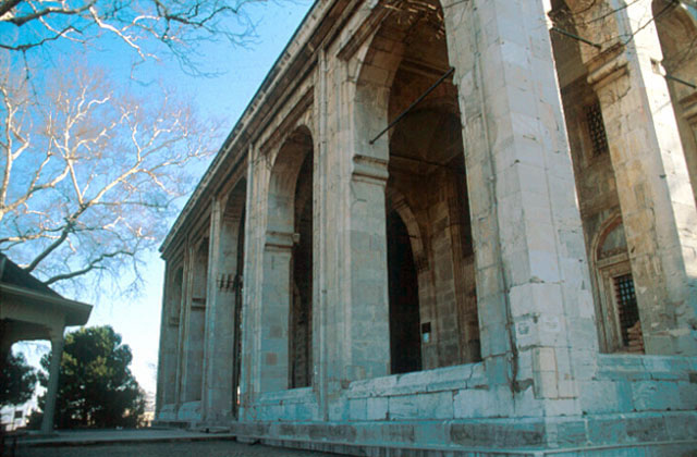 Exterior view of the five bay portico of the mosque, from the northwest, with the ablution fountain seen to the left