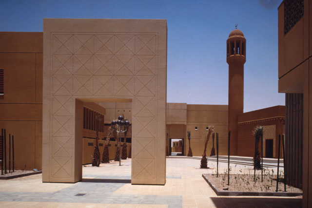 Exterior view showing architectonic arch and minaret