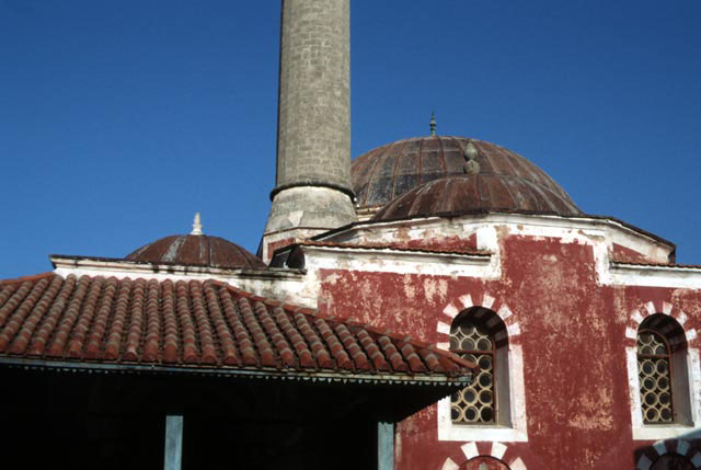 Exterior view showing portico roof and mosque domes