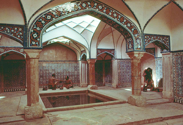 Interior view of hot room, washing area with square pool and wax mannequins