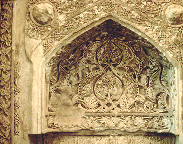Detail of mihrab showing floral stucco decoration in hood of niche