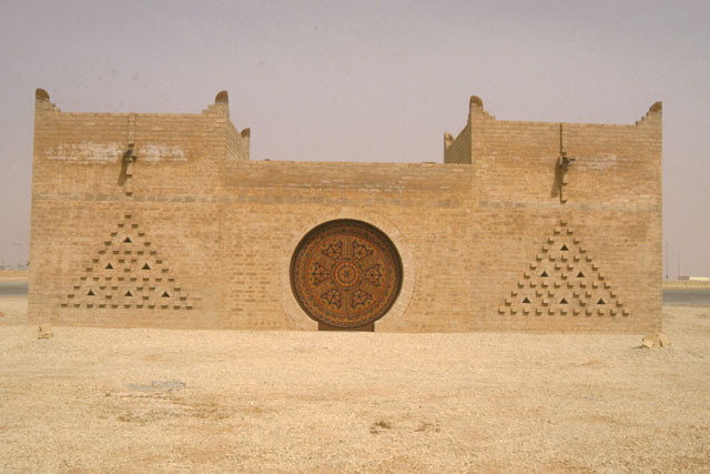 Exterior view of brick façade with inset wooden roundel