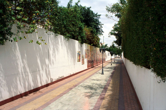 Exterior view along walkway with planted walls