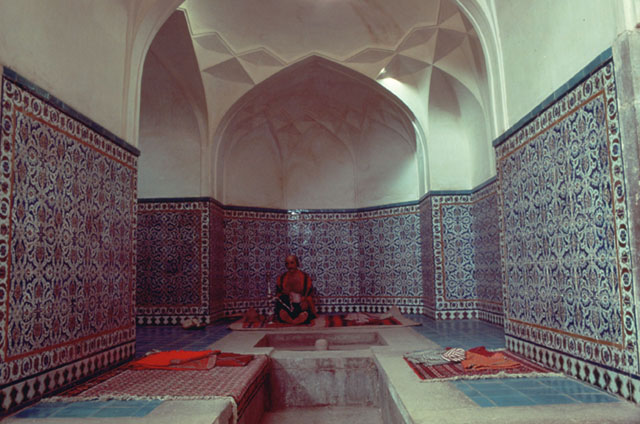 Interior view;  resting area with tile dado and polygonal niche, with wax mannequin