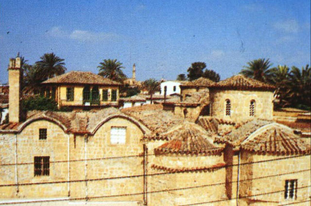 Rooftops in historic walled city, with Byzantine structure in the foreground