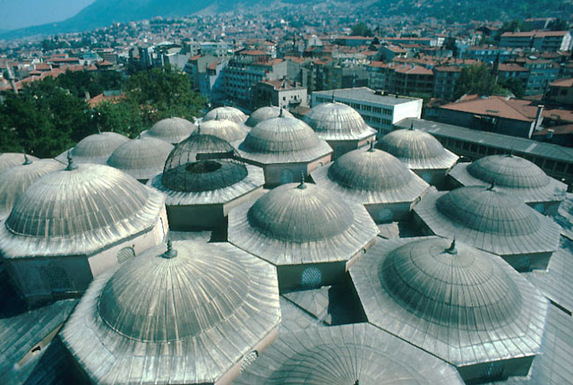 Aerial view of the multi-domed roof showing the semi-spherical metal cage in the center that protects the glazed oculus above fountain in court inside
