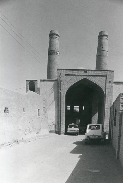 Exterior view showing front elevation with main portal, topped by minarets
