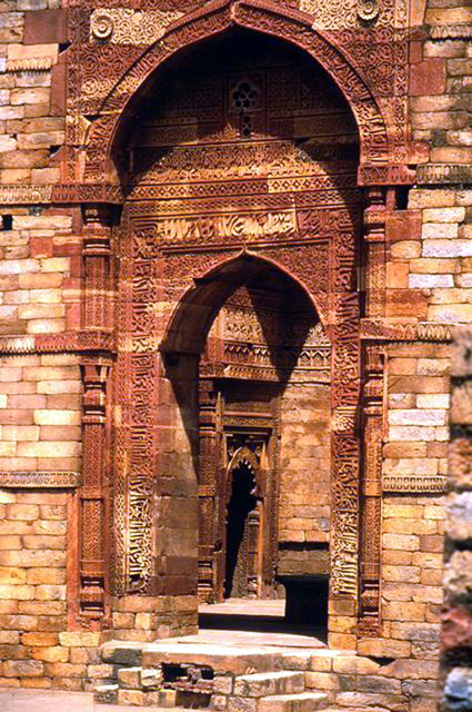 Exterior detail of doorway of mosque complex showing stone carvings and inscriptions