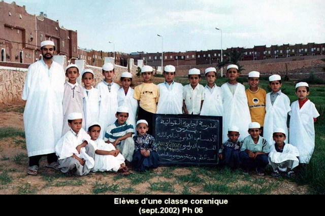 General view of new housing, with students from Quranic school posed in front