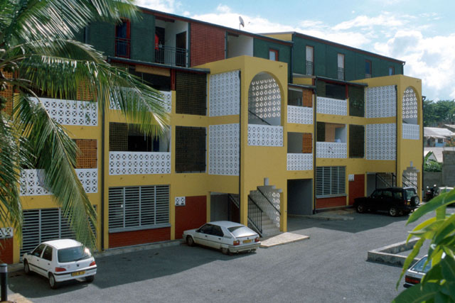 Exterior view showing modular façades with concrete screens of balconies