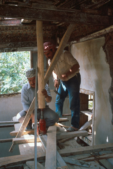 Interior detail showing workers erecting roof supports