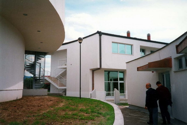 Princess Dzevhera Islamic Center - Exterior view of apartment / office block (center), with kindergarten entrance at right