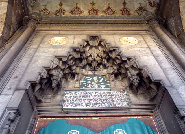 Foundation inscription and tughra on mosque portal with flattened muqarnas hood