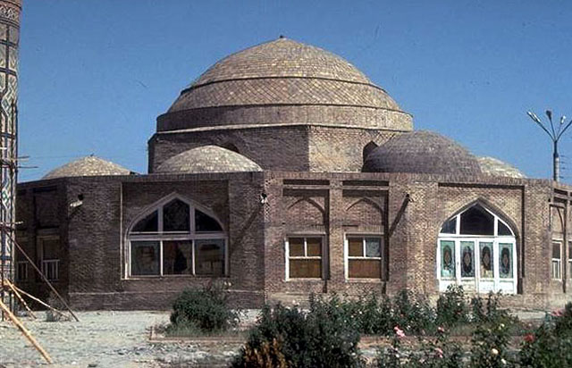 Exterior view  of façade and large central cupola surrounded by smaller domes