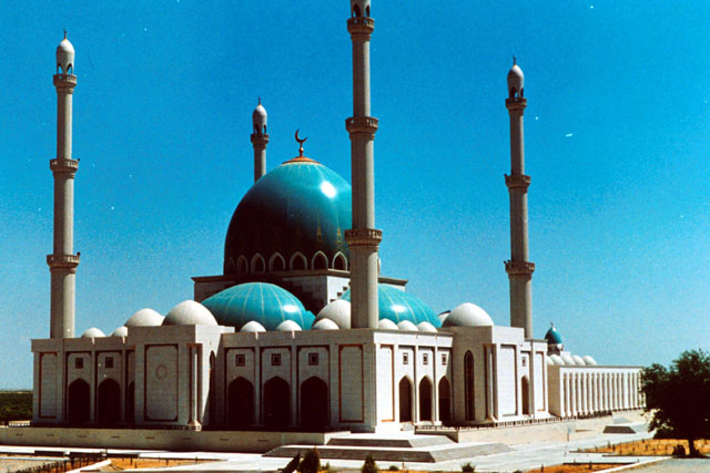 Exterior view showing towering minaret and formations of domes