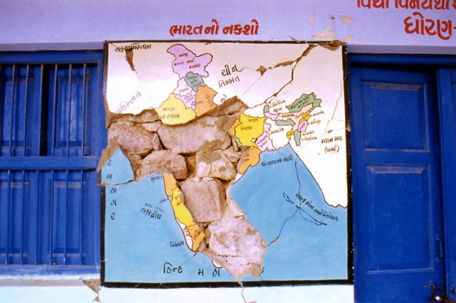 Wall with map, cracked by the earthquake