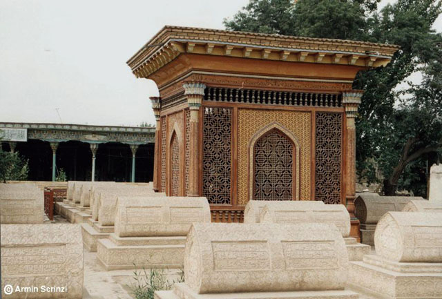 Screened kiosk surrounded by cenotaphs with prayer hall in background