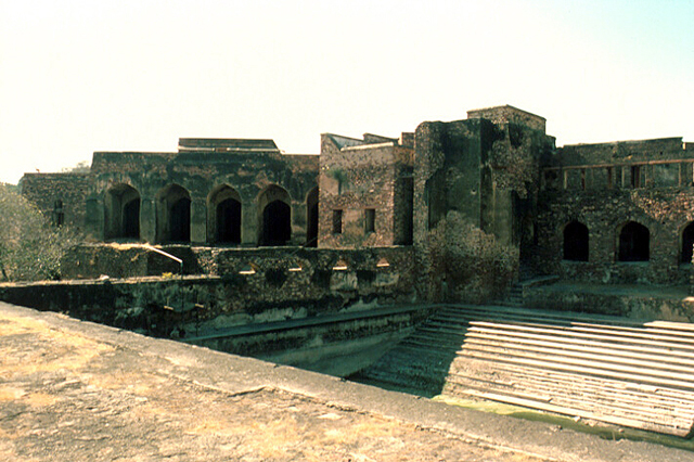 Exterior view toward north showing façades with arches, and stairs leading to a subterranean level