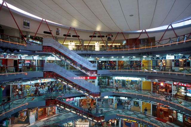 Interior view showing arcade of shops around atrium