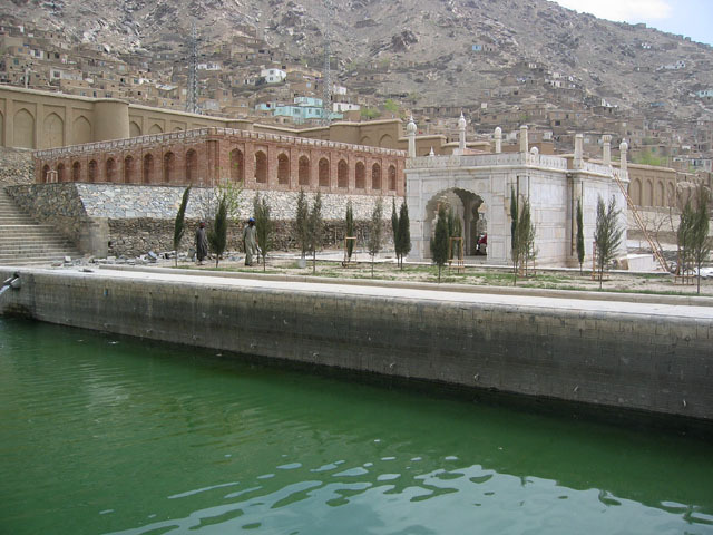 Exterior view of mosque across the water reservoir, after restoration, with the outer grave enclosure seen behind