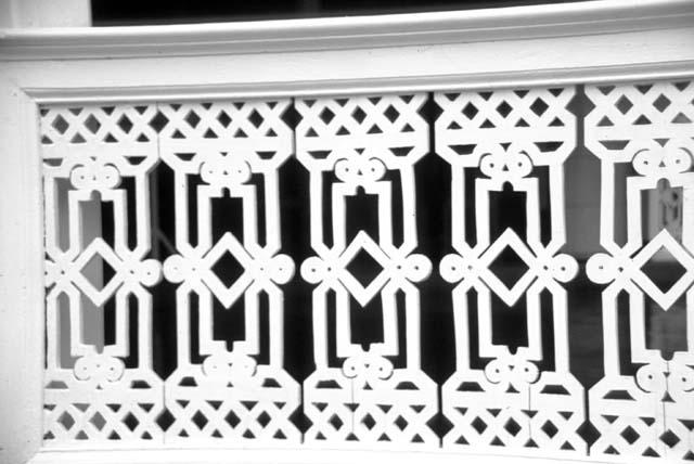 Detail of woodwork on railing of porte-cochere