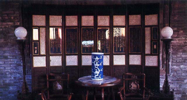 Interior of fourth court tablet gallery with furniture, screen, and vase