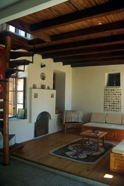 Interior detail showing wood beam roof and stucco walls
