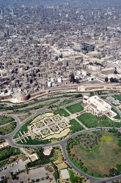 Aerial view of park looking northwest towards the Hilltop Restaurant, preceded by formal gardens. The Darb al-Ahmar neighborhood is seen behind the Ayyubid city walls
