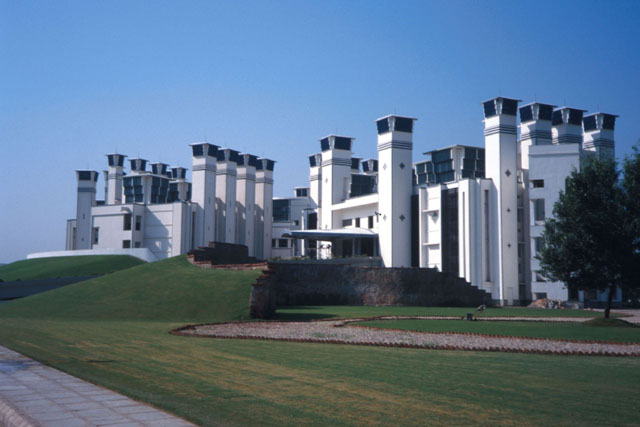 Exterior view showing intake towers on the roof and exhaust towers on the periphery of the building