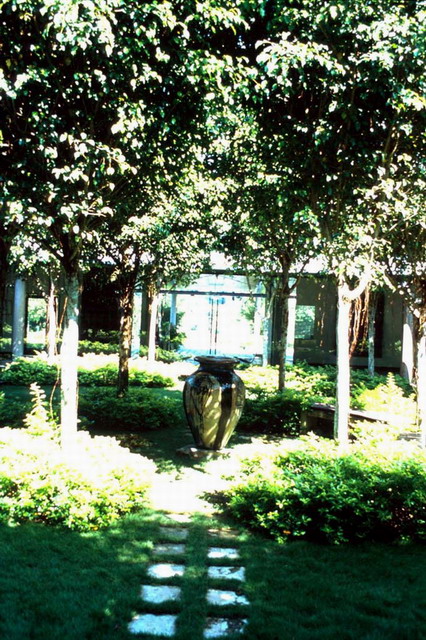 Serene garden, heart of building main entrance in distance