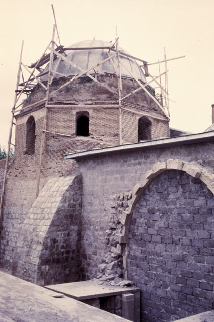 Exterior view from southeast showing sanctuary dome during restoration and archway of blocked portal