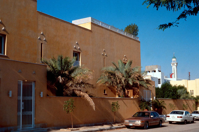Exterior view showing protective wall and stucco façade