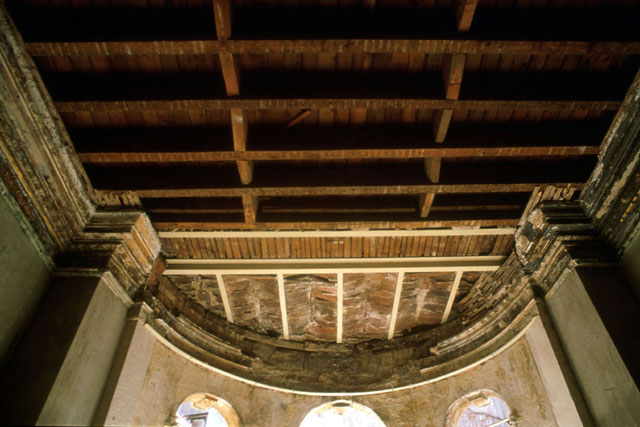 Interior detail of wood and brick ceiling construction before restoration