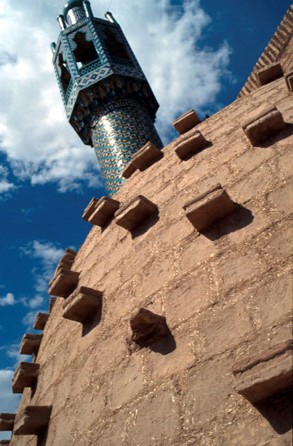 Detail, earth-brick wall surface and minaret