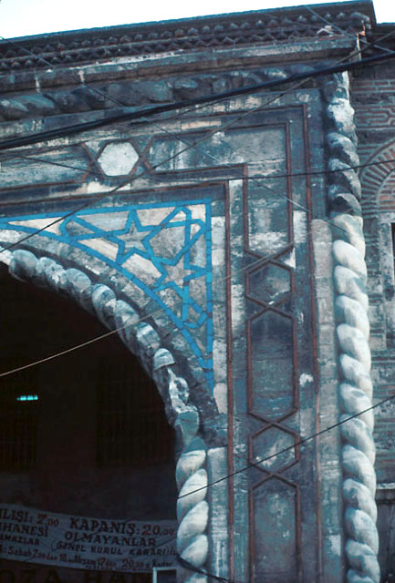 Exterior detail from portal decorated with cable moulding on the edges and blue tiles on the façade