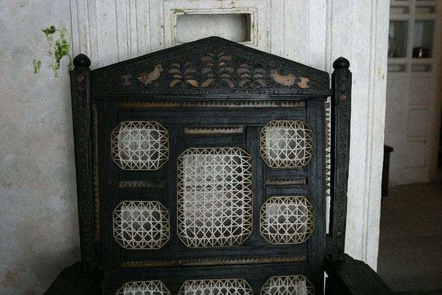 Detail view of nineteenth century Swahili chair crafted from African ebony inlaid with bone and ivory