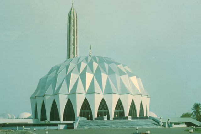 Exterior view showing plinth supporting dome-shaped prayer hall