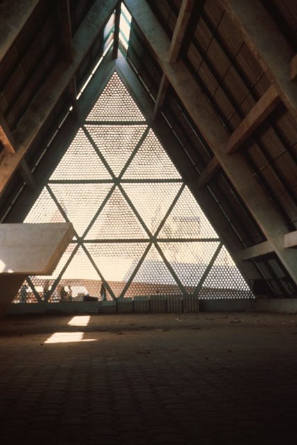 Interior view through dramatic floor to ceiling perforated screen