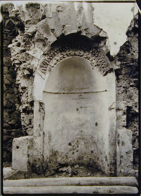 Mihrab niche with carved classical motifs below arch